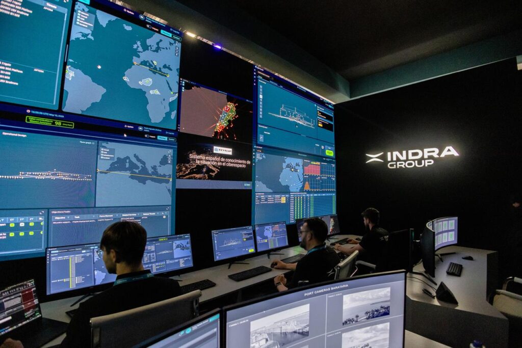 IT professionals sit in a control room, managing defense systems.